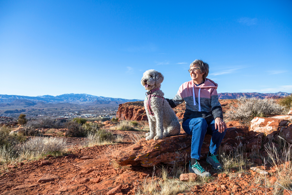 Happy,Senior,Woman,On,An,Outdoor,Hike,With,Her,Dog.